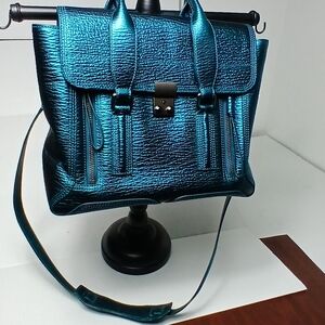 3.1 Phillip Lim Medium Pashli satchel bag in metallic blue embossed leather. 
